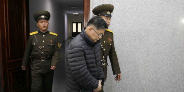 Hyeon Soo Lim, center, who pastors the Light Korean Presbyterian Church in Toronto, is escorted to his sentencing in Pyongyang, North Korea, Wednesday, Dec. 16, 2015. North Korea's Supreme Court sentenced a Canadian pastor to life in prison with hard labor on Wednesday for what it called crimes against the state. (AP Photo/Jon Chol Jin)