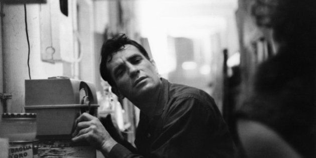 American Beat writer Jack Kerouac (1922 - 1969) leans closer to a radio to hear himself on a broadcast, 1959. (Photo by John Cohen/Getty Images)