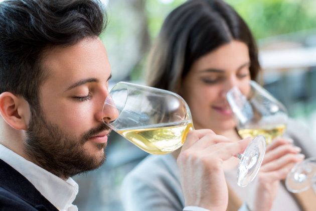 56695248 - close up portrait of young couple tasting white wine tasting.