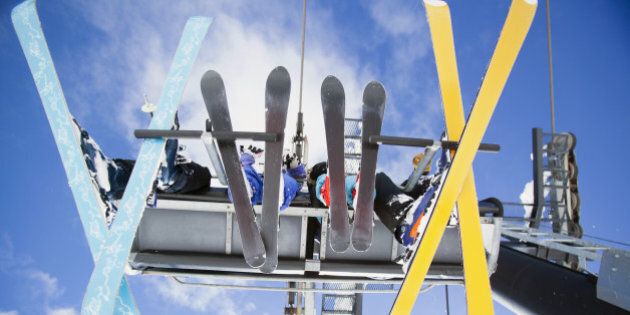 USA, Montana, Whitefish, Family of skiers on ski lift seen from below