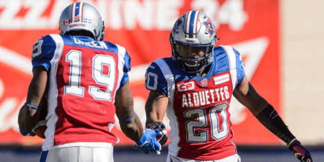 MONTREAL, QC - SEPTEMBER 20: S.J. Green #19 of the Montreal Alouettes celebrates his touchdown with teammate Tyrell Sutton #20 during the CFL game against the Winnipeg Blue Bombers at Percival Molson Stadium on September 20, 2015 in Montreal, Quebec, Canada. The Montreal Alouettes defeated the Winnipeg Blue Bombers 35-14. (Photo by Minas Panagiotakis/Getty Images)