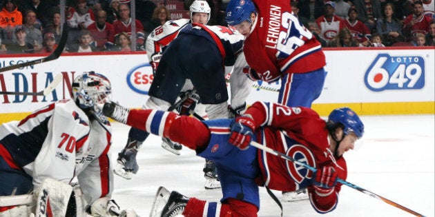 Feb 4, 2017; Montreal, Quebec, CAN; Montreal Canadiens right wing Sven Andrighetto (42) falls in front of Washington Capitals goalie Braden Holtby (70) and left wing Artturi Lehkonen (62) during the second period at Bell Centre. Mandatory Credit: Jean-Yves Ahern-USA TODAY Sports