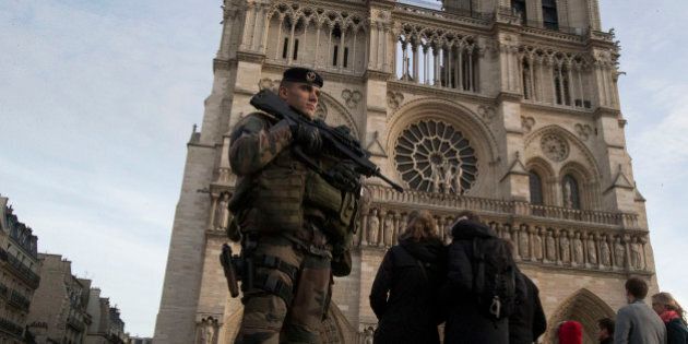 A soldier patrols at the Notre Dame cathedral in Paris, Wednesday, Dec. 30, 2015. France's defense minister has visited troops on duty ahead of unusually tense New Year's Eve celebrations in Paris after November attacks that left 130 dead and hundreds injured. (AP Photo/Michel Euler)