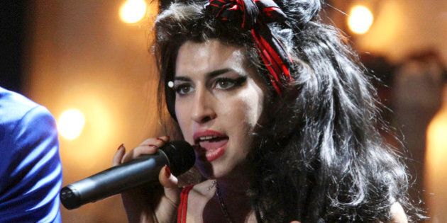 U.S. musician Mark Ronson and British singer Amy Winehouse perform at the Brit Awards 2008 in London, Wednesday, Feb. 20, 2008. (AP Photo/Matt Dunham)