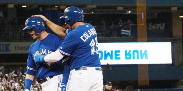 TORONTO, ON- OCTOBER 19: Chris Colabello congratulates Troy Tulowitzki after he hit a home run. The Toronto Blue Jays and the Kansas City Royals play game three of the MLB American League Championship Series at Rogers Centre in Toronto. October 19, 2015. (Steve Russell/Toronto Star via Getty Images)