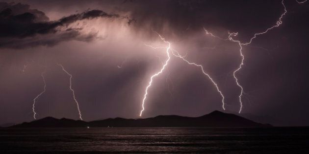 KOS, GREECE - JUNE 03: Lightning strikes over the Greek Island of Pserimos on June 03, 2015 in Kos, Greece. Migrants are continuing to arrive on the Greek Island of Kos from Turkey who's shoreline lies approximately 5 Km away. Around 30,000 migrants have entered Greece so far in 2015, with the country calling for more help from its European Union counterparts. (Photo by Dan Kitwood/Getty Images)