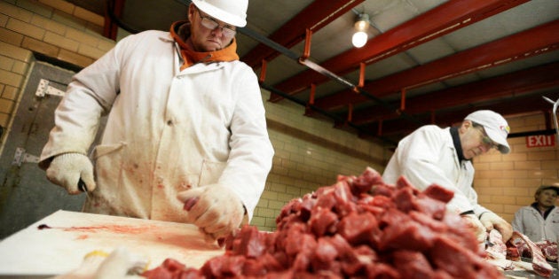 Amend Packing Company worker Chris Jorgensen, left, cuts stew meat, Tuesday, Feb. 17, 2015, in Des Moines, Iowa. Demand for local beef is surging but people who slaughter cattle and slice the beef into steaks say few people want to go into the business. Nationally, there were 1,200 federally inspected livestock slaughterhouses in the U.S. in 1990. By 2010 the number had dropped to 800. (AP Photo/Charlie Neibergall)