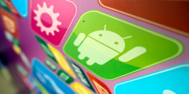 A logo for Google Inc.'s Android operating system is displayed on an advertising sign during the Apps World Multi-Platform Developer Show in London, U.K., on Wednesday, Oct. 23, 2013. Retail sales of Internet-connected wearable devices, including watches and eyeglasses, will reach $19 billion by 2018, compared with $1.4 billion this year, Juniper Research said in an Oct. 15 report. Photographer: Chris Ratcliffe/Bloomberg via Getty Images