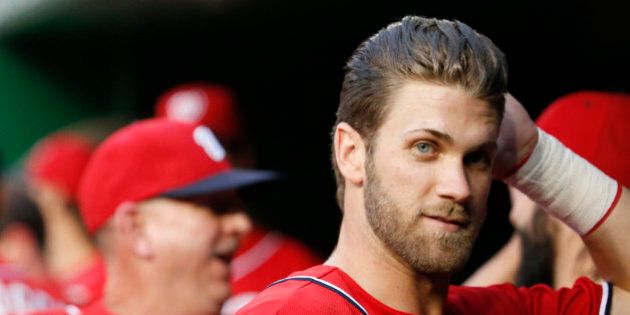 Washington Nationals right fielder Bryce Harper (34) pauses in the dugout before a baseball game against the San Francisco Giants at Nationals Park, Sunday, July 5, 2015, in Washington. (AP Photo/Alex Brandon)