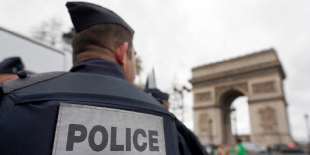 Police forces patrol near the landmark, the Arc de Triomphe, in Paris, Tuesday, Nov. 17, 2015. France's Interior Minister Bernard Cazeneuve has said that authorities carried out