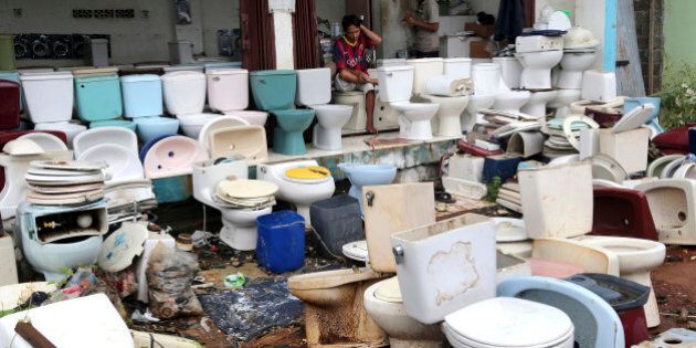 A vendor selling used toilets waits for customers at a market in Jakarta, Indonesia Wednesday, March, 25, 2015. (AP Photo/Tatan Syuflana)