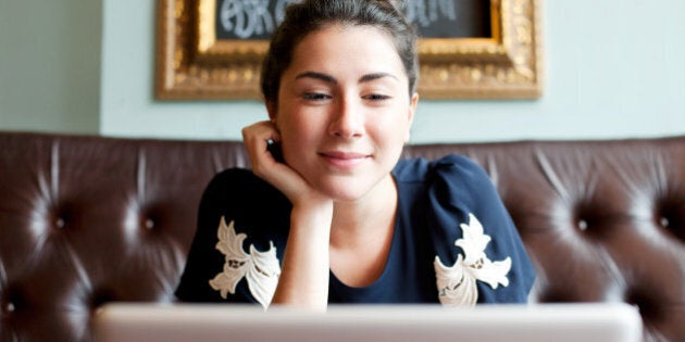 Woman looking at screen in cafe.