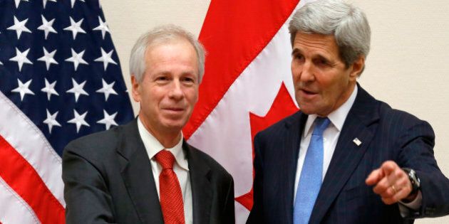 Canadian Foreign Minister Stephane Dion (L) meets with U.S. Secretary of State John Kerry alongside NATO ministerial meetings at NATO Headquarters in Brussels, Belgium December 1, 2015. / AFP / POOL / JONATHAN ERNST (Photo credit should read JONATHAN ERNST/AFP/Getty Images)