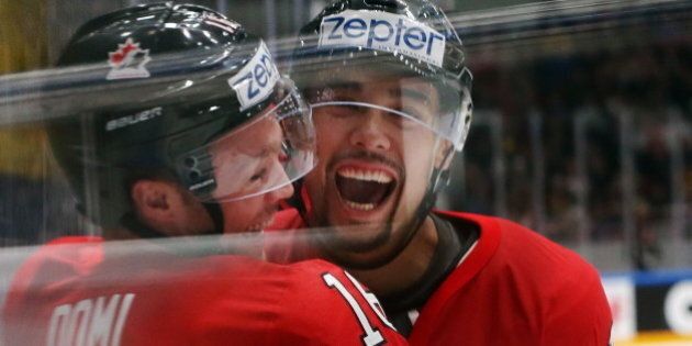 Canada's Max Domi (L) and Matt Dumba celebrate scoring in their 2016 IIHF World Championship quarter-final ice hockey match against Sweden at the Yubileyny Sports Palace in St. Petersburg, Russia, May 19, 2016. Sergei Savostyanov/TASS (Photo by Sergei Savostyanov\TASS via Getty Images)