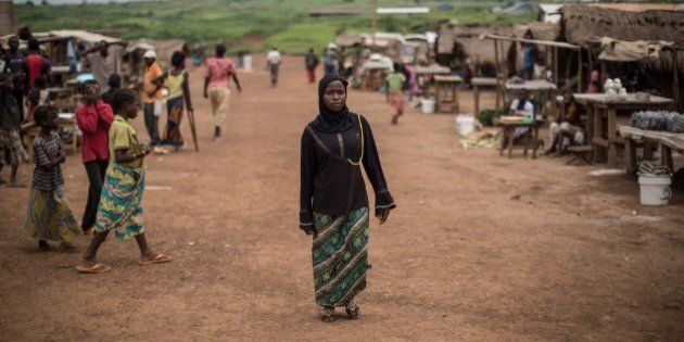 A Muslim refugee form Central African Republic, walks along a street at the Mole refugee camp, 35 Kms south of Zongo, at the Equator region, on June 20, 2015, as nations mark World Refugee Day. About 17000 Central African Republic (CAR) refugees live in this area, located near Bangui, after fleeing brutal inter-religious violence in 2013-2014. The United Nations this week reported that 60 million people -- half of them children -- have been forced to flee conflict and persecution. AFP PHOTO/FEDERICO SCOPPA (Photo credit should read FEDERICO SCOPPA/AFP/Getty Images)