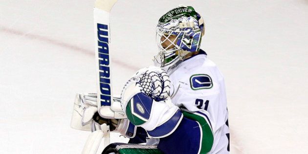 Vancouver Canucks goalie Eddie Lack celebrates after the third period of an NHL hockey game against the San Jose Sharks in San Jose, Calif., Saturday, March 7, 2015. The Canucks won 3-2. (AP Photo/Jeff Chiu)