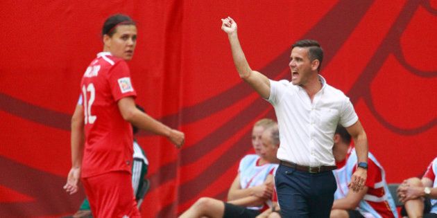 VANCOUVER, BC - JUNE 21: Christine Sinclair #12 of Canada looks on as Canada coach John Herdman yells during the FIFA Women's World Cup Canada 2015 Round 16 match between Switzerland and Canada June 21, 2015 at BC Place Stadium in Vancouver, British Columbia, Canada. (Photo by Jeff Vinnick/Getty Images)