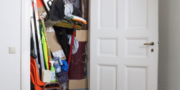 A closet stuffed with various storage items
