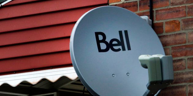 A Bell Canada television satellite is mounted outside of a home in Toronto, Ontario, Canada, on Thursday, July 28, 2011. Bell is Canada's largest communications company, providing telephone services, mobile communications, high-speed Internet and digital television. Photographer: Brent Lewin/Bloomberg via Getty Images