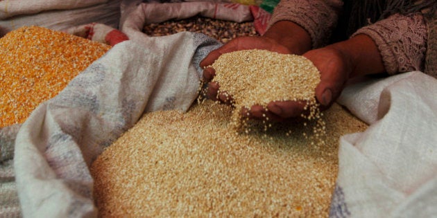 A woman shows her quinoa grain for sale at a market in La Paz, Bolivia, Friday March 2, 2012. Bolivian authorities say at least 30 people have been injured in a fight between two communities over land for growing quinoa, the Andean