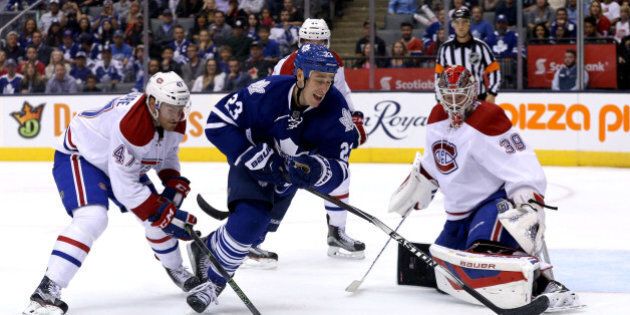 TORONTO, ON - SEPTEMBER 26 - Toronto's Shawn Matthias (centre) has his stick broken by Montreal's Jeremy Gregoire (left) while trying to shoot on goalie Mike Condon during the pre-season game between the Toronto Maple Leafs and the Montreal Canadians at the Air Canada Centre on September 26, 2015. (Carlos Osorio/Toronto Star via Getty Images)