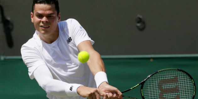 Milos Raonic of Canada returns a ball to Nick Kyrgios of Australia during their singles match at the All England Lawn Tennis Championships in Wimbledon, London, Friday July 3, 2015. (AP Photo/Tim Ireland)