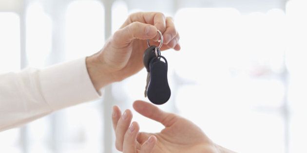 Car salesman handing keys to customer