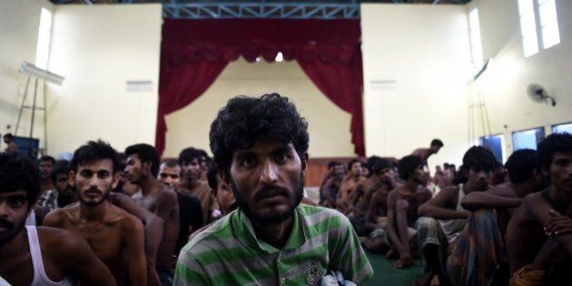 An illegal Bangladeshi migrant waits at the Police headquarters in Langkawi on May 11, 2015 after landing on Malaysian shores earlier in the day. Nearly 2,000 boat people from Myanmar and Bangladesh have been rescued or swum to shore in Malaysia and Indonesia, authorities said, warning that still more desperate migrants could be in peril at sea. AFP PHOTO / MANAN VATSYAYANA (Photo credit should read MANAN VATSYAYANA/AFP/Getty Images)
