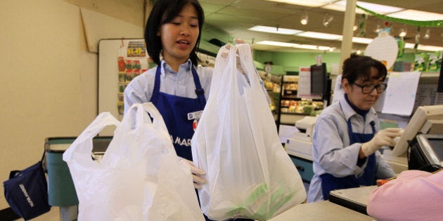 SAN FRANCISCO - JUNE 02: A cashier bags groceries in plastic bags at Nijiya Market June 2, 2010 in San Francisco, California. California may become the first state in the nation to ban plastic bags from grocery and convenience stores. In addition to the ban, consumers would be charged 5 cents per paper bag if they do not bring their own reusable bags. Assembly bill AB1998 is supported by Gov. Arnold Schwarzengger and is expected to pass an assembly vote this week before moving to the State Senate for a vote later this year. (Photo by Justin Sullivan/Getty Images)