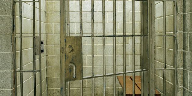 Empty prison cell with door open