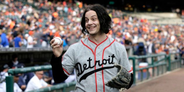 FILE - In this July 29, 2014 file photo, musician Jack White shows off a baseball before throwing out the ceremonial first pitch before the Detroit Tigers baseball game against the Chicago White Sox in Detroit. White is planning a return to his Detroit roots with a new Third Man Records store. White and Shinola, a business that makes watches and other goods in Detroit, announced Tuesday, June 2, 2015, they've partnered to buy the building housing Shinola. (AP Photo/Duane Burleson)