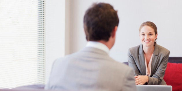 Business people talking face to face in lobby