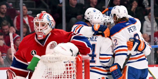 MONTREAL, QC - FEBRUARY 12: Ryan Nugent-Hopkins #93 of the Edmonton Oilers celebrate with teammates after scoring a goal against the Montreal Canadiens in the NHL game at the Bell Centre on February 12, 2015 in Montreal, Quebec, Canada. (Photo by Francois Lacasse/NHLI via Getty Images)