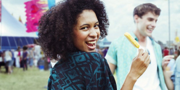 Portrait of woman eating flavored ice at music festival