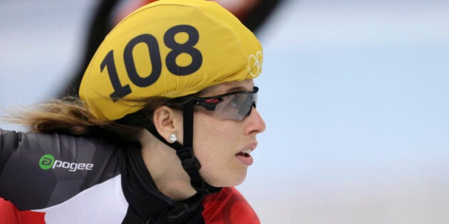 Marianne St-gelais of Canada looks at the timing board after competing in a women's 500m short track speedskating heat at the Iceberg Skating Palace during the 2014 Winter Olympics, Monday, Feb. 10, 2014, in Sochi, Russia. (AP Photo/Darron Cummings)