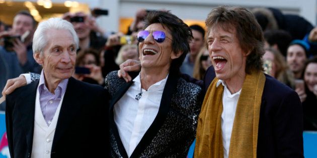Members of the Rolling Stones (L-R) Charlie Watts, Ronnie Wood and Mick Jagger laugh as they arrive for the