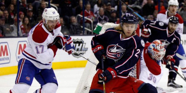 Columbus Blue Jackets' William Karlsson, right, of Sweden, works against Montreal Canadiens' Torrey Mitchell during the second period of an NHL hockey game in Columbus, Ohio, Monday, Jan. 25, 2016. (AP Photo/Paul Vernon)