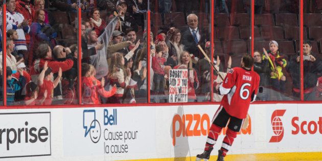 OTTAWA, ON - JANUARY 24: After a win against the New York Rangers, Bobby Ryan #6 of the Ottawa Senators gives a souvenir stick to the family who had a sign promising their son a puppy if Ryan were to score a goal in the game (which he did) at Canadian Tire Centre on January 24, 2016 in Ottawa, Ontario, Canada. (Photo by Andre Ringuette/NHLI via Getty Images)