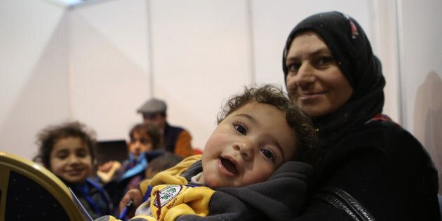 Syrian refugees wait at Marka Airport in Amman, Jordan, on Tuesday, Dec. 8, 2015 to complete their migration procedures to Canada,which has announced that it will take around 25,000 Syrians from Jordan, Lebanon and Turkey. (AP Photo/Raad Adayleh)