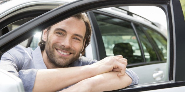 Man leaning out of his car window