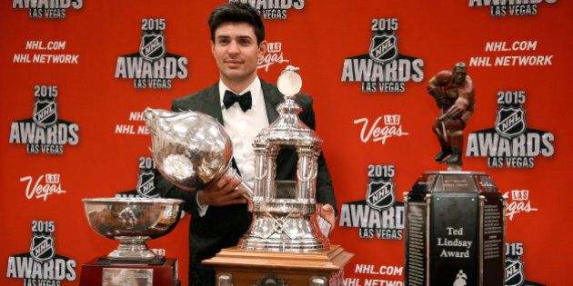 Montreal Candiens' Carey Price poses with trophies for awards he won at the NHL Awards show Wednesday, June 24, 2015, in Las Vegas. Form left are the William M. Jennings trophy, the Vezina Trophy, the Ted Lindsay Award trophy and the Art Ross trophy. (AP Photo/John Locher)