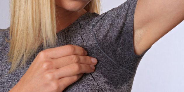 Sport woman armpit sweating. Transpiration stain. Hyperthyroidism concept