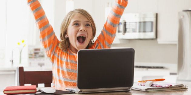 USA, Utah, Lehi, Excited girl (6-7) with laptop