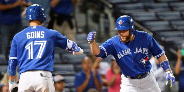 Toronto Blue Jays' Russell Martin (55) celebrates with Ryan Goins (17) after hitting a two-run home run in the ninth inning of a baseball game against the Atlanta Braves Wednesday, Sept. 16, 2015, in Atlanta. (AP Photo/John Bazemore)