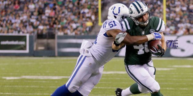 New York Jets fullback Tommy Bohanon (40) is tackled by Indianapolis Colts linebacker Henoc Muamba (51) in the second quarter of a preseason NFL football game, Thursday, Aug. 7, 2014, in East Rutherford, N.J. (AP Photo/Frank Franklin II)