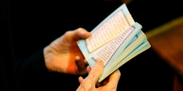 A Shiite woman reads the Quran, Islam's holy book, at the shrine of Imam Ali, the son-in-law and cousin of the Prophet Muhammad and the first Imam of the Shiites, during the anniversary of his death, in the Shiite holy city of Najaf, 100 miles (160 kilometers) south of Baghdad, Iraq, early Friday, July 10, 2015. (AP Photo/ Hadi Mizban)