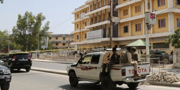 MOGADISHU, SOMALIA - JANUARY 2: Somalian security forces on patrol around the he scene of a suicide attack at a restaurant near the presidential palace in the capital Mogadishu, Somalia on January 2, 2016. (Photo by Nour Gelle Gedi /Anadolu Agency/Getty Images)