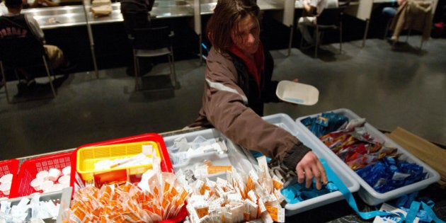 TO GO WITH AFP STORY by Laurent VU THE, Canada-society-drugs-healthA client of the Insite supervised injection Center in Vancouver, Canada, collects her kit on May 3, 2011. The Canadian Supreme Court is to settle a conflict between the government's wishes to close the center and the center's success in fighting the spread of AIDS among drug addicts. In eight years of existence, and with more 600 visits per day on average, Insite believes it has made advances in the fight against AIDS. And in a radius of 500 meters around the center, deaths by overdose dropped by 35 percent since the opening, according to a study published in the medical newspaper The Lancet. AFP PHOTO/Laurent Vu The (Photo credit should read Laurent Vu The/AFP/Getty Images)