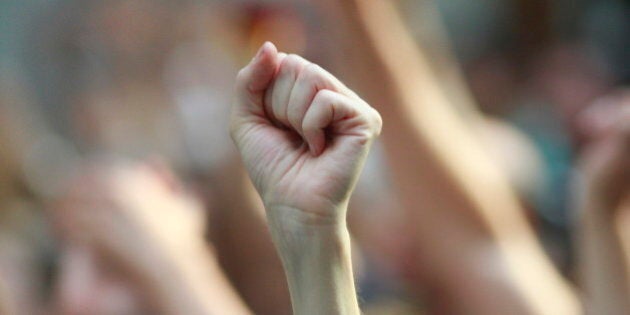 A raised fisted arm to express support.