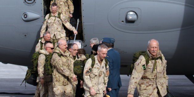 The last Canadian troops to leave Afghanistan, deplane as they return to Canadian soil, in Ottawa, Ontario on March 18, 2014. The last Canadian troops deployed to Afghanistan returned home on Tuesday, bringing an end to Canada's longest ever military engagement. AFP PHOTO/ Cole Burston (Photo credit should read Cole Burston/AFP/Getty Images)